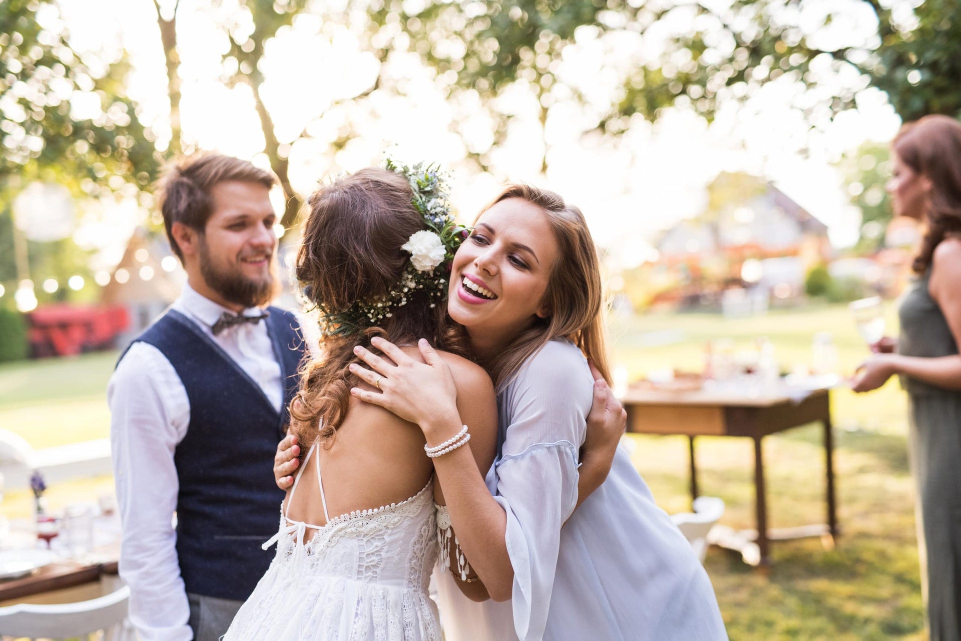 bride hugs bridesmaid at wedding