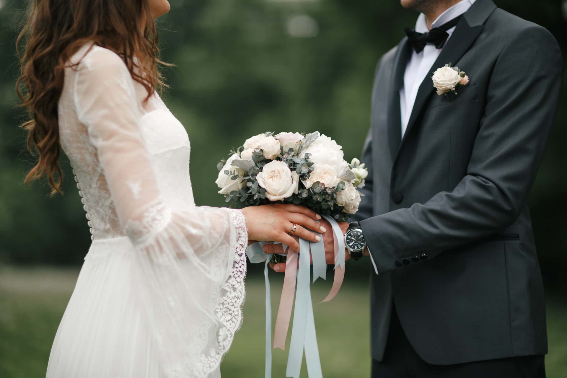 couple holding wedding bouquet